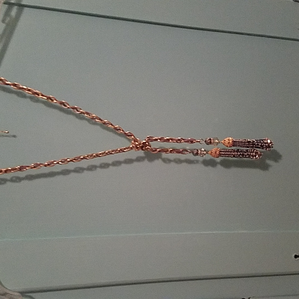 Necklace goldtone chain with silver tone tassels. Gray leather woven in